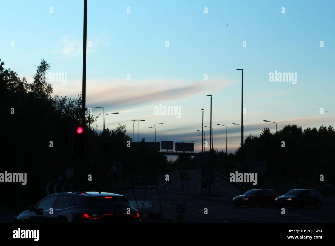 Pretty sky (sunset) above a road junction in Manchester, England Stock Photo
