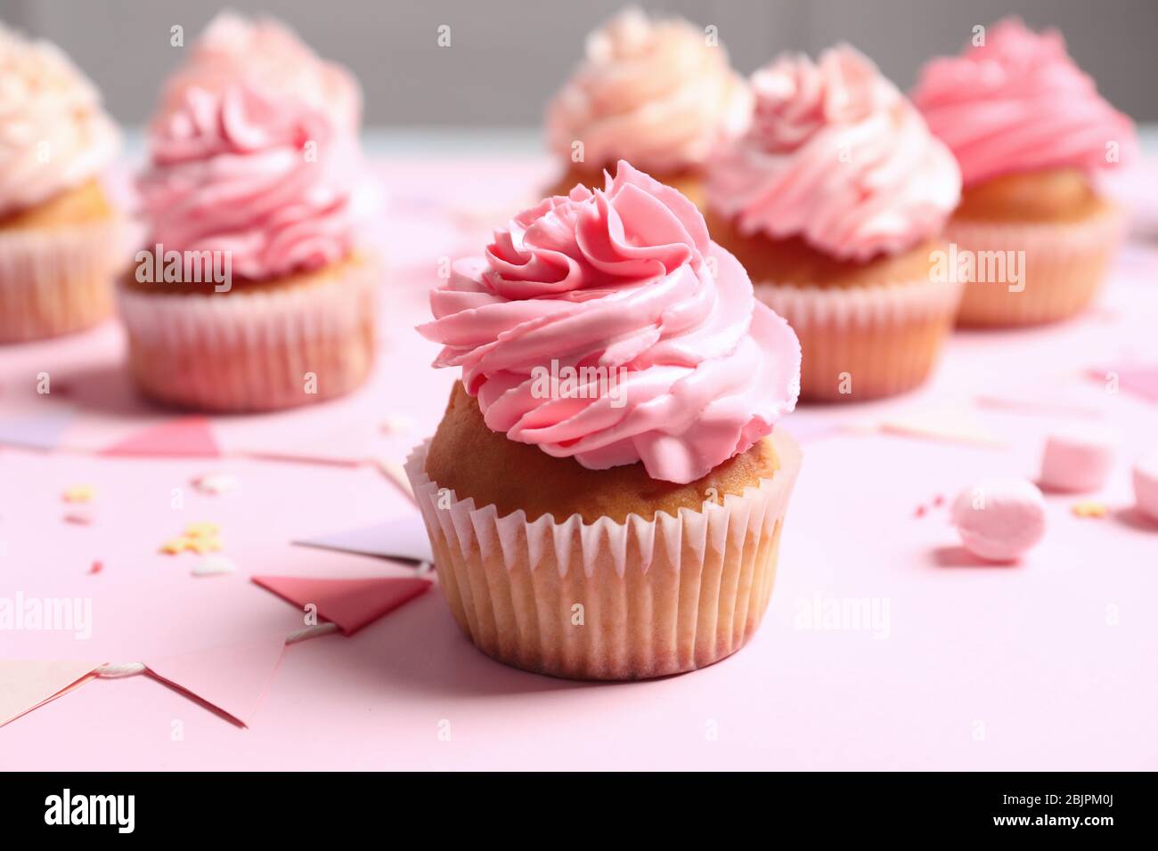 Many yummy cupcakes on table Stock Photo