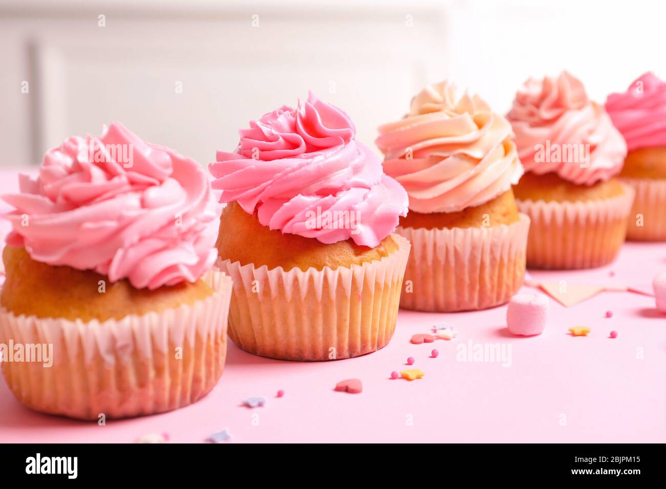 Many yummy cupcakes on table Stock Photo