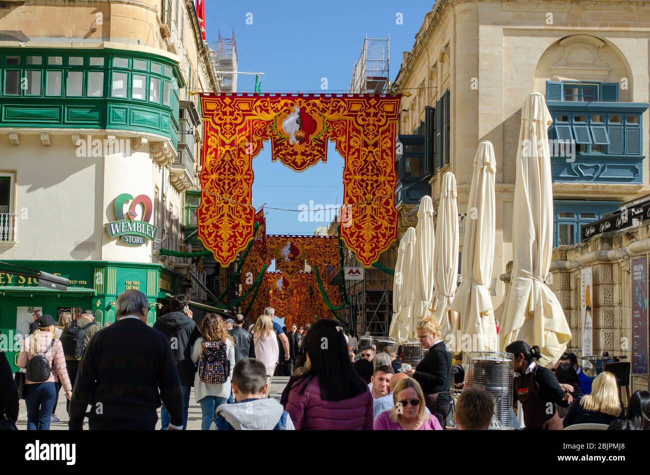 Valleta Malta 8 February 2020:  Crowd in street for  Feast of St Paul's Shipwreck with colourful  banners Stock Photo