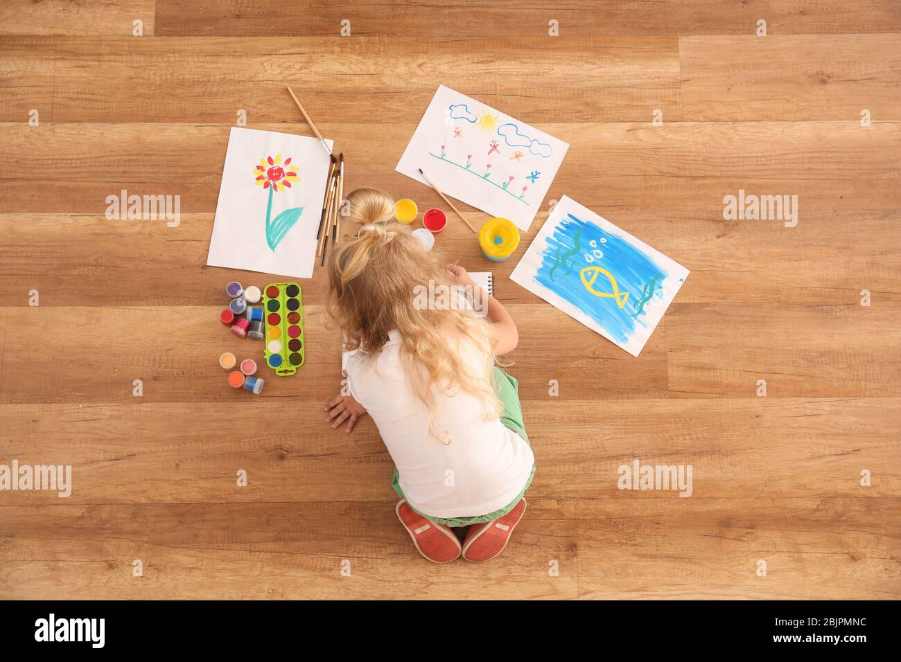 Cute girl painting picture on sheet of paper, indoors Stock Photo - Alamy