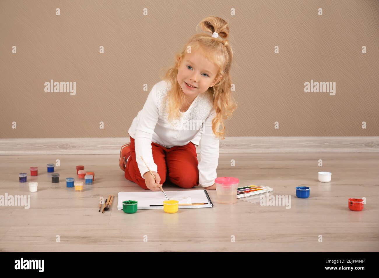Cute girl painting picture on sheet of paper, indoors Stock Photo - Alamy