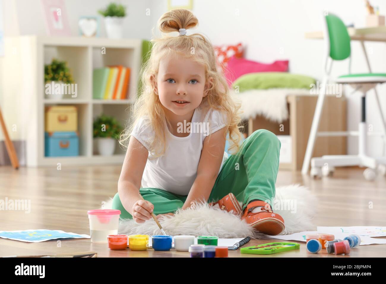 Cute girl painting picture on sheet of paper, indoors Stock Photo - Alamy