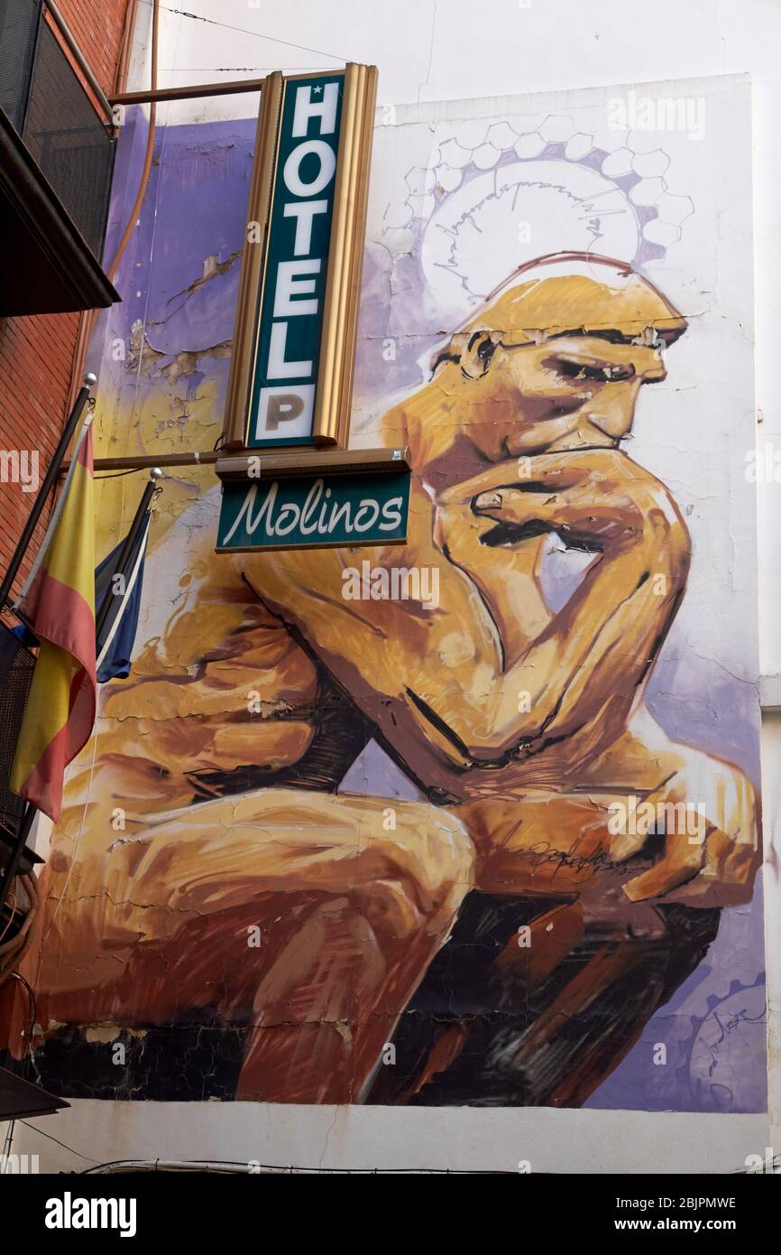 Street art by Spanish artist El Niño de las Pinturas, aka Raul Ruiz, in Barrio Realejo, Granada, Spain. Stock Photo