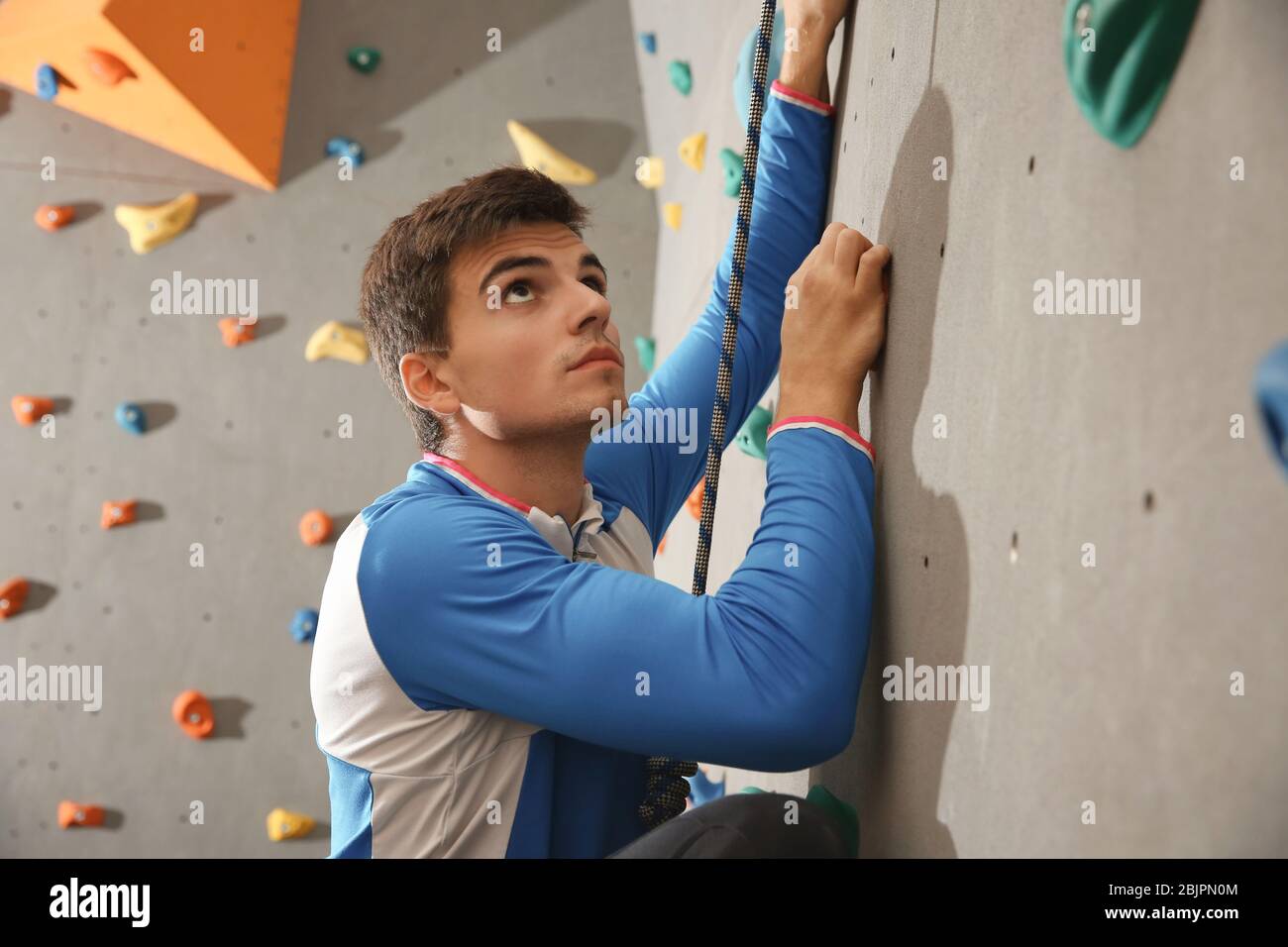 Handsome man climbing rock hi-res stock photography and images - Alamy