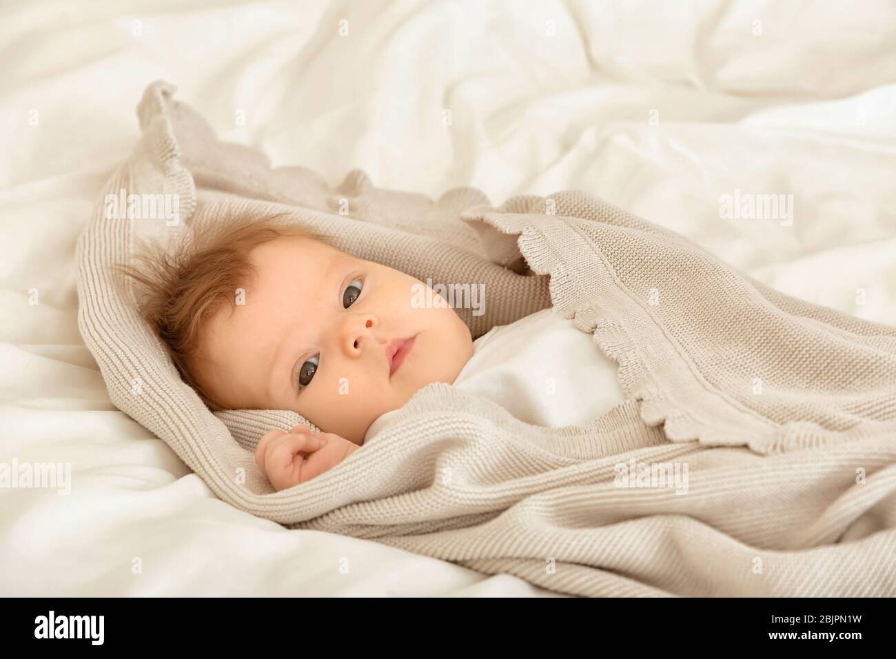 Cute little baby lying on bed at home Stock Photo - Alamy