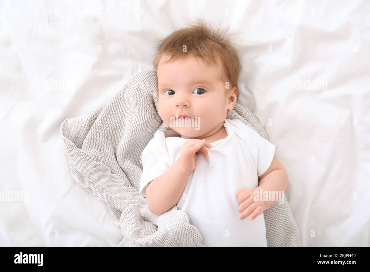 Cute little baby lying on bed at home Stock Photo - Alamy