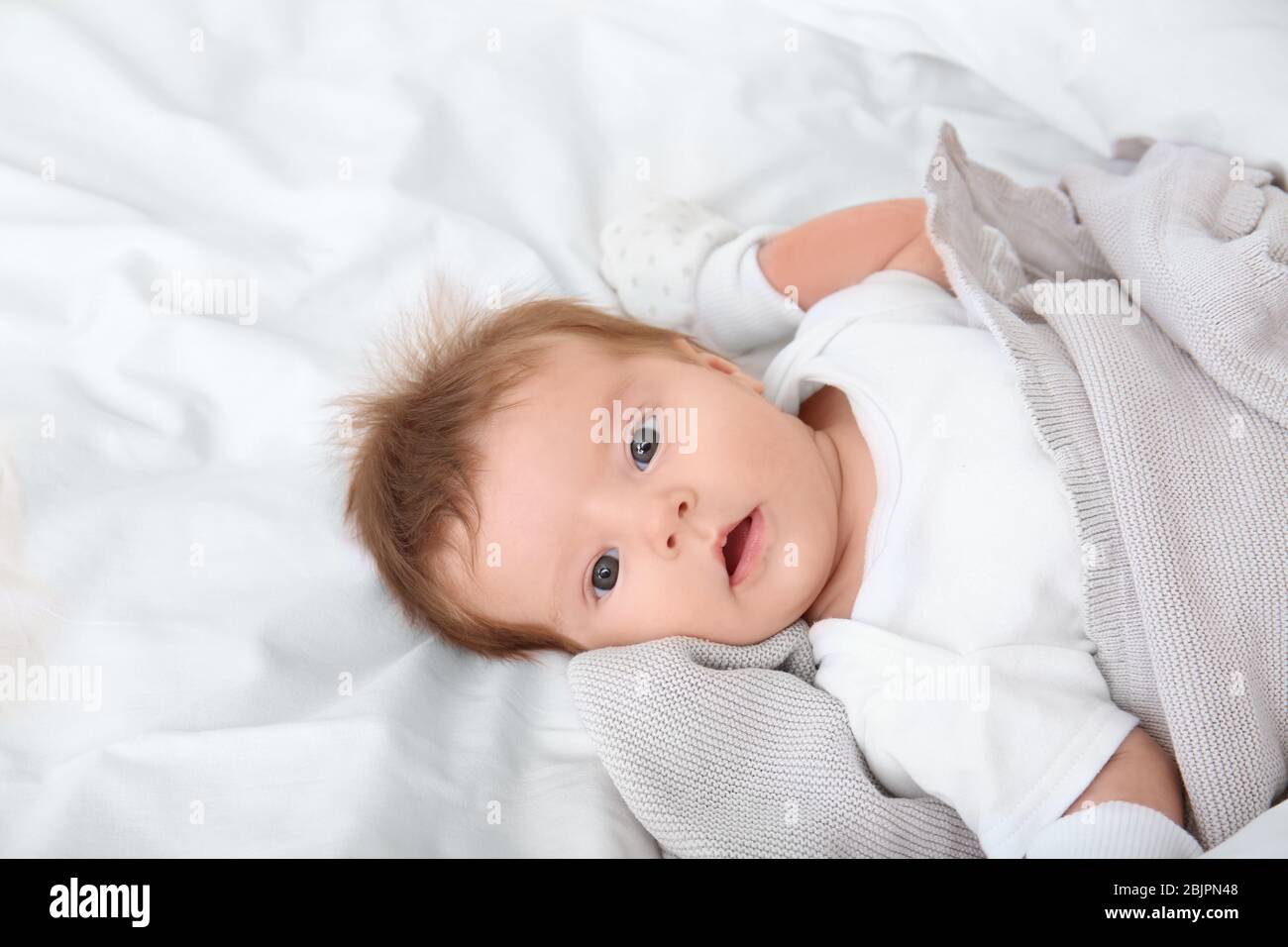 Cute little baby lying on bed at home Stock Photo - Alamy