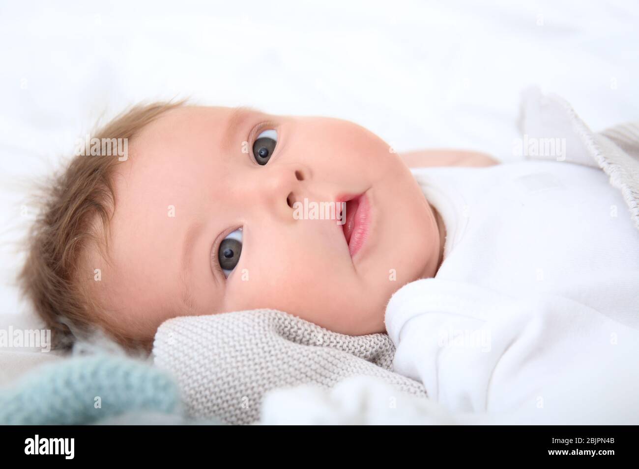 Cute little baby lying on bed at home Stock Photo - Alamy