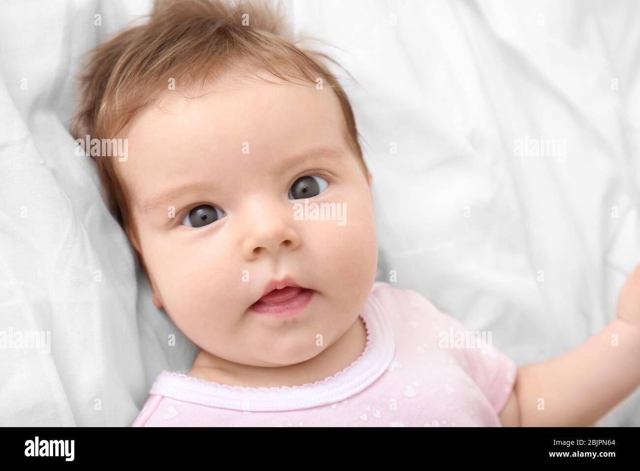 Cute little baby lying on bed at home Stock Photo - Alamy
