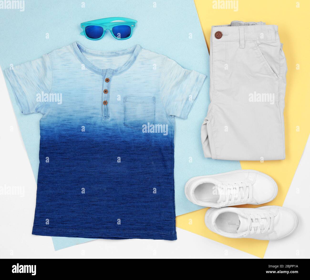 Set of child’s clothes on color background Stock Photo - Alamy