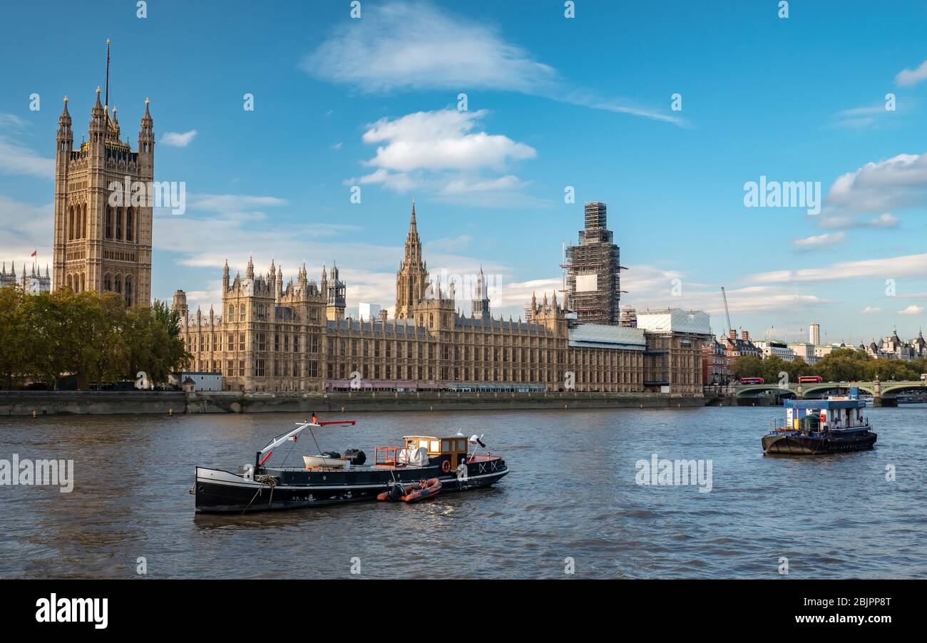 Palace of Westminster and The Houses of Parliament, London, with St. Stephen's Tower (Big Ben) shrouded in scaffolding due to repairs. Stock Photo