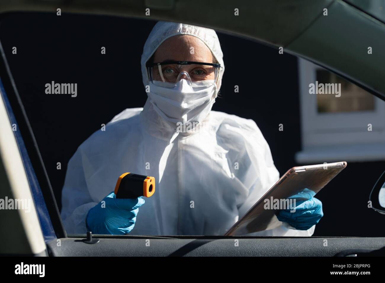 Caucasian woman wearing a lab overalls and coronvirus covid19 mask outsdide Stock Photo