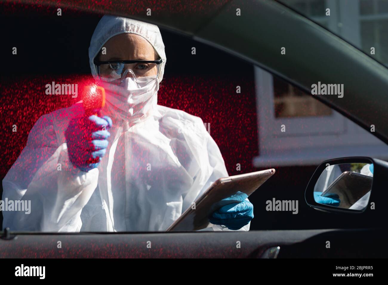 Caucasian woman wearing a lab overalls and coronvirus covid19 mask outsdide Stock Photo