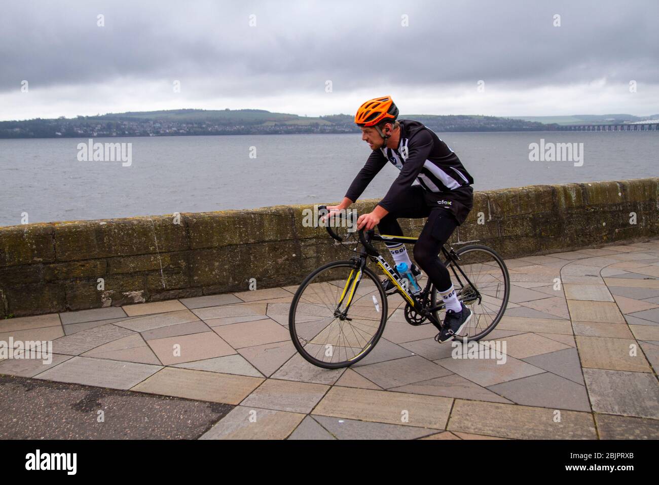 Dundee, Tayside, Scotland, UK. 30th Apr, 2020. UK Weather: A blustery cold and cloudy morning in Dundee with temperatures reaching 9°C. Local residents take cycling exercises along the waterfront promenade during the Covid-19 lockdown restrictions throughout Scotland. Credit: Dundee Photographics/Alamy Live News Stock Photo