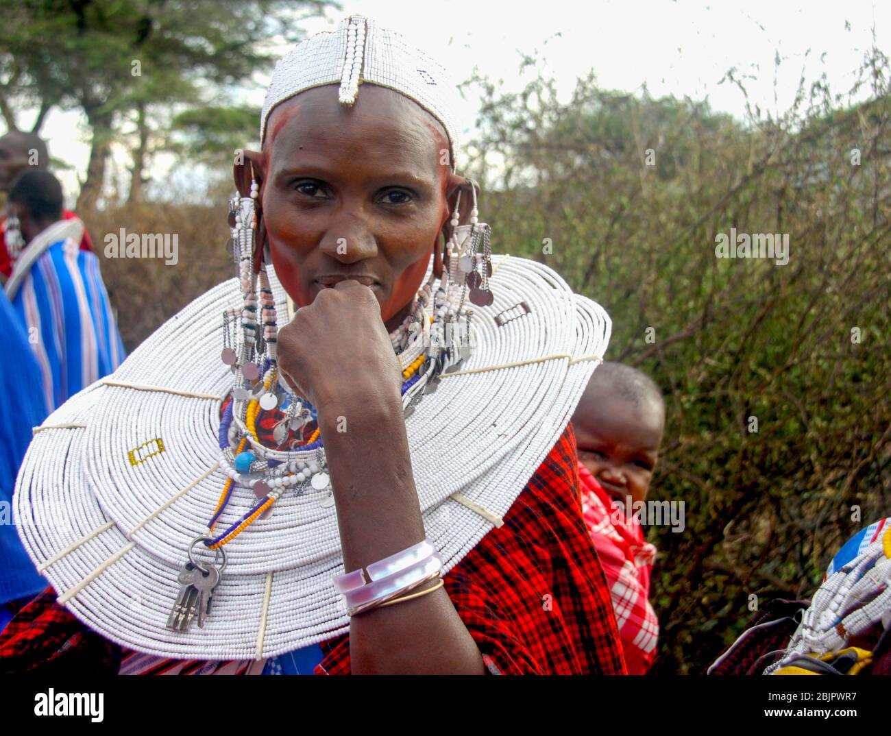 Maasai women in full traditional party outfit, wearing Maasai jewelry. Maasai is an ethnic group of semi-nomadic people Photographed in Tanzania Stock Photo