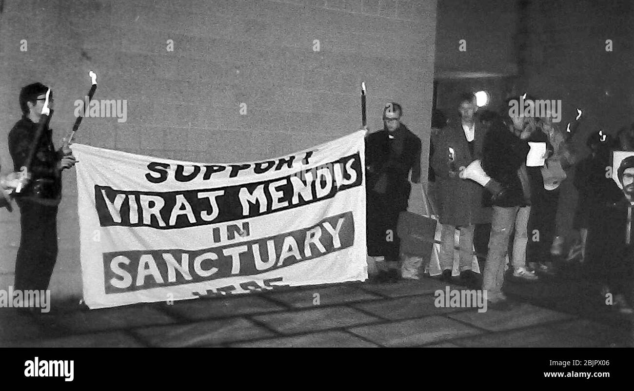 A torchlight vigil in 1987 in support of Viraj Mendis, a Sri Lankan national who claimed the right of sanctuary at the Church of the Ascension in Hulme, Manchester, England, uk.  He overstayed his visa and claimed danger of death if he was sent back to Sri Lanka. The vigil took place outside the church. In January 1989 police entered the church and arrested Mendis. He was deported back to Sri Lanka. It is reported that his fears did not materialise. Mendis claimed his case had received so much publicity that the Sri Lankan government did not dare to harm him. Stock Photo