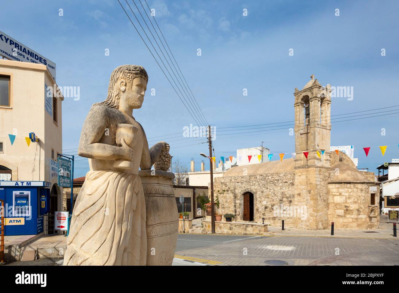 A statue and Agios Nikolaos church in the centre of the town of Polis, Cyprus Stock Photo