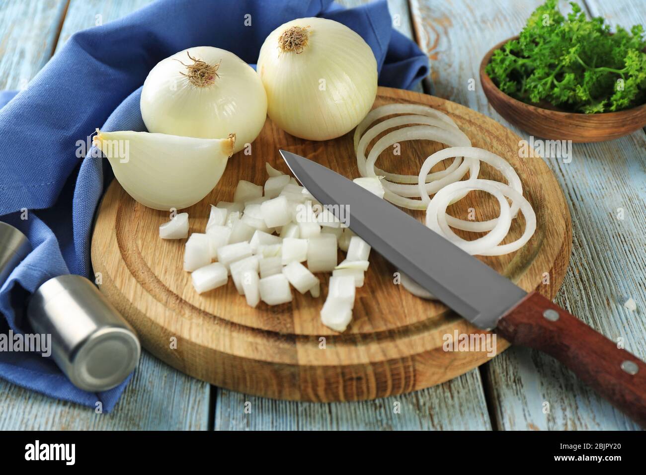 Wooden board with cut white onion on table Stock Photo - Alamy