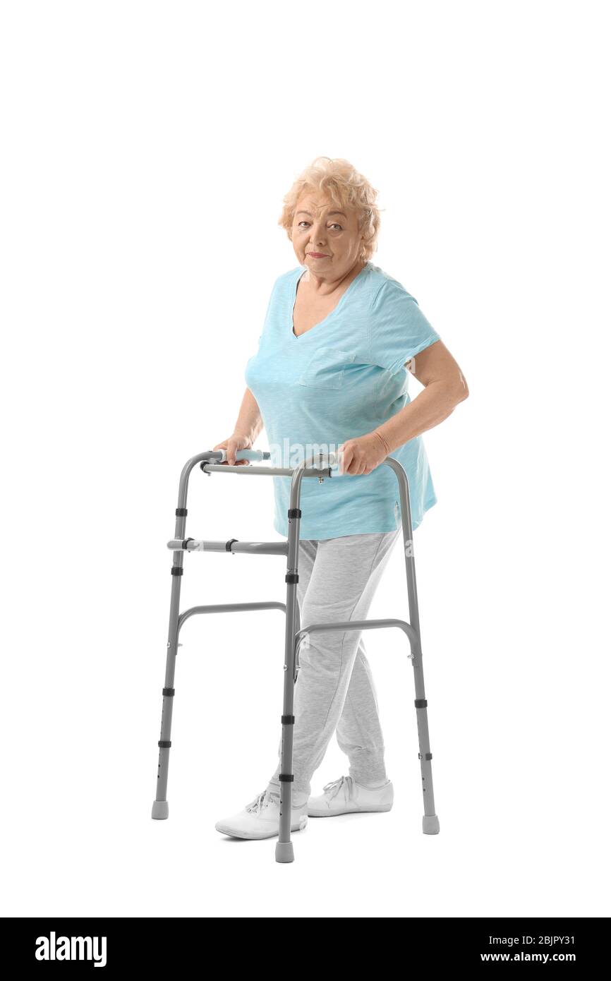 Elderly woman with walking frame on white background Stock Photo Alamy