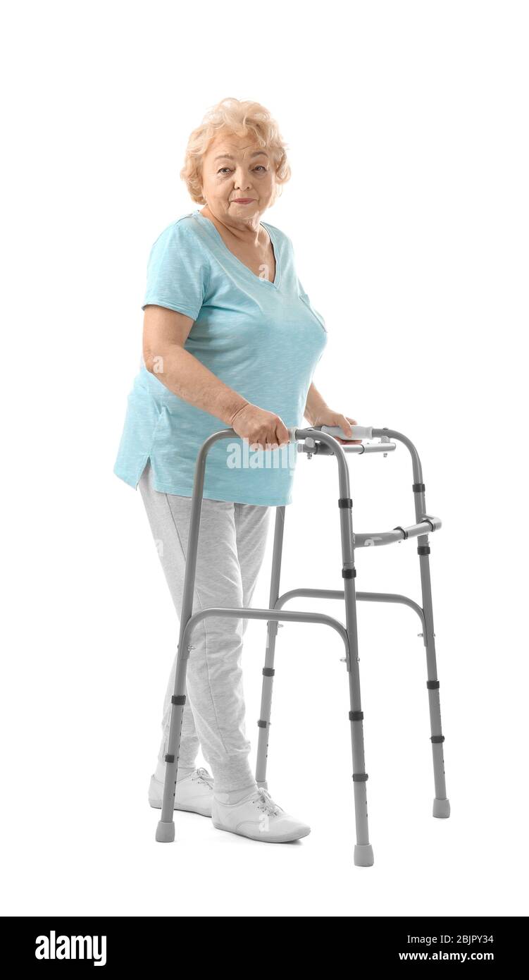Elderly woman with walking frame on white background Stock Photo - Alamy