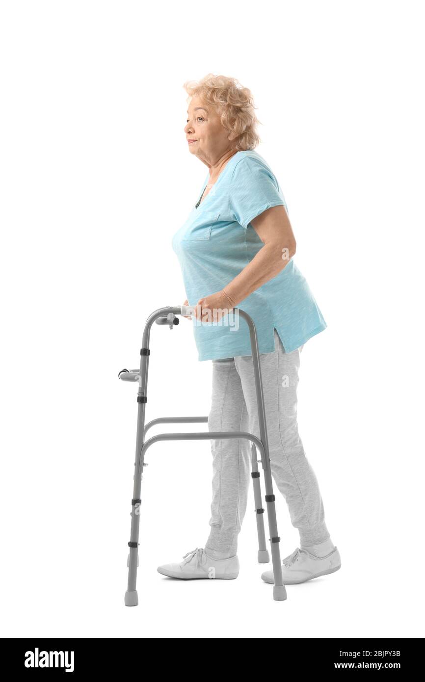 Elderly woman with walking frame on white background Stock Photo - Alamy
