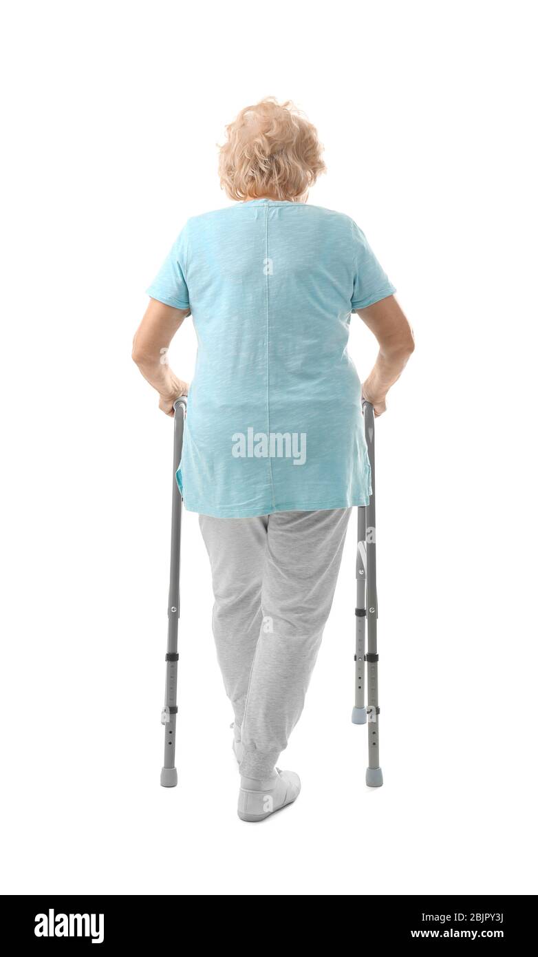Elderly woman with walking frame on white background Stock Photo - Alamy