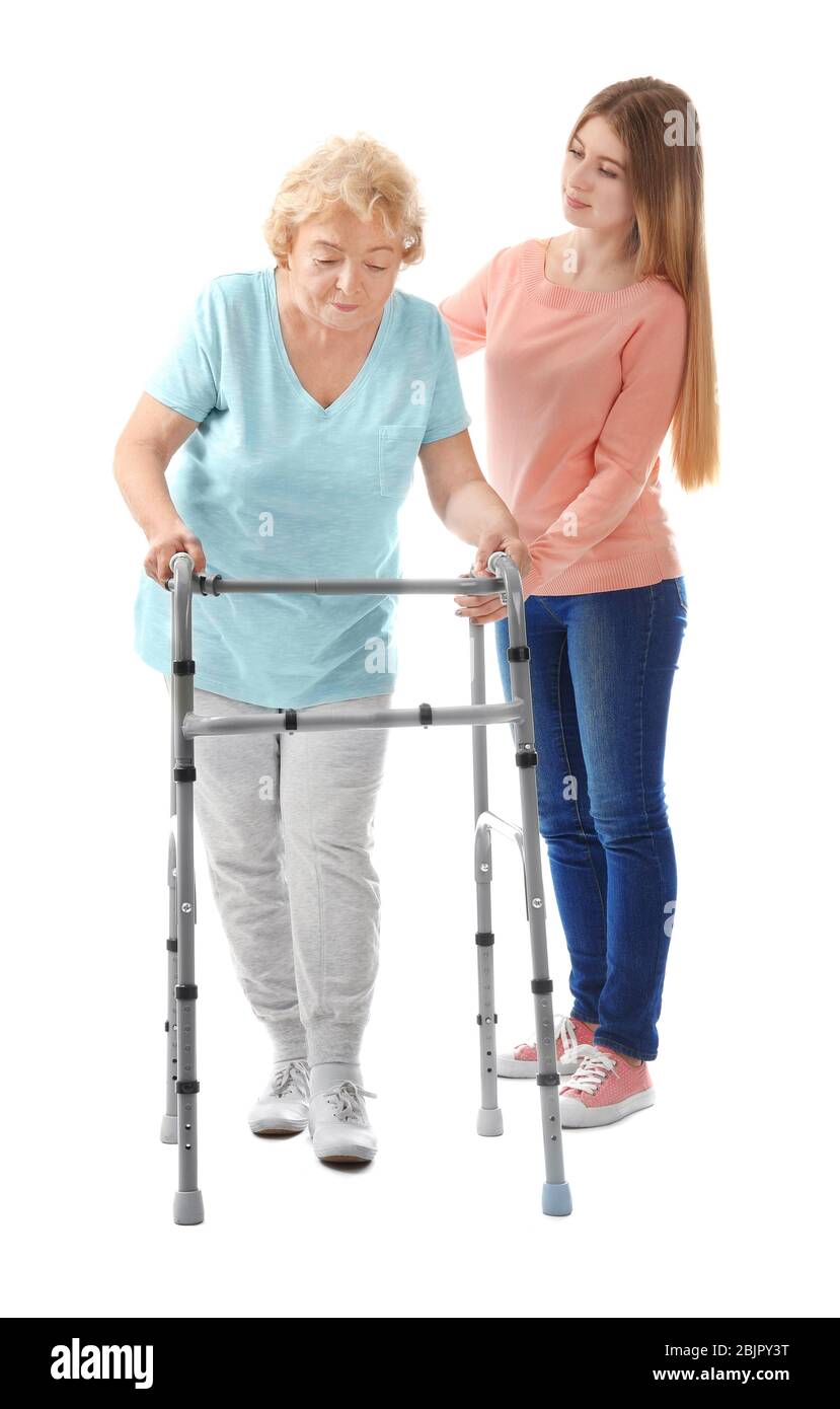 Young woman and her elderly grandmother with walking frame on white ...