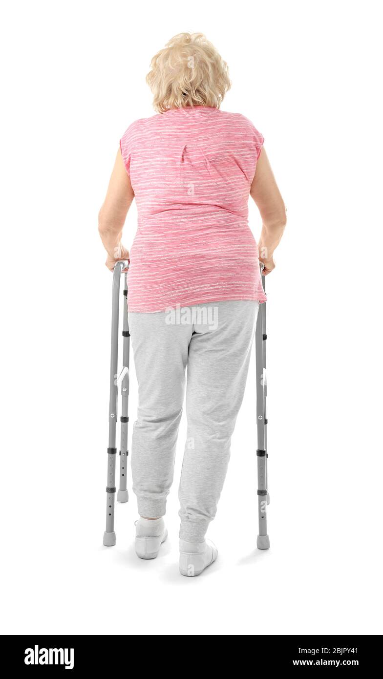 Elderly woman with walking frame on white background Stock Photo - Alamy