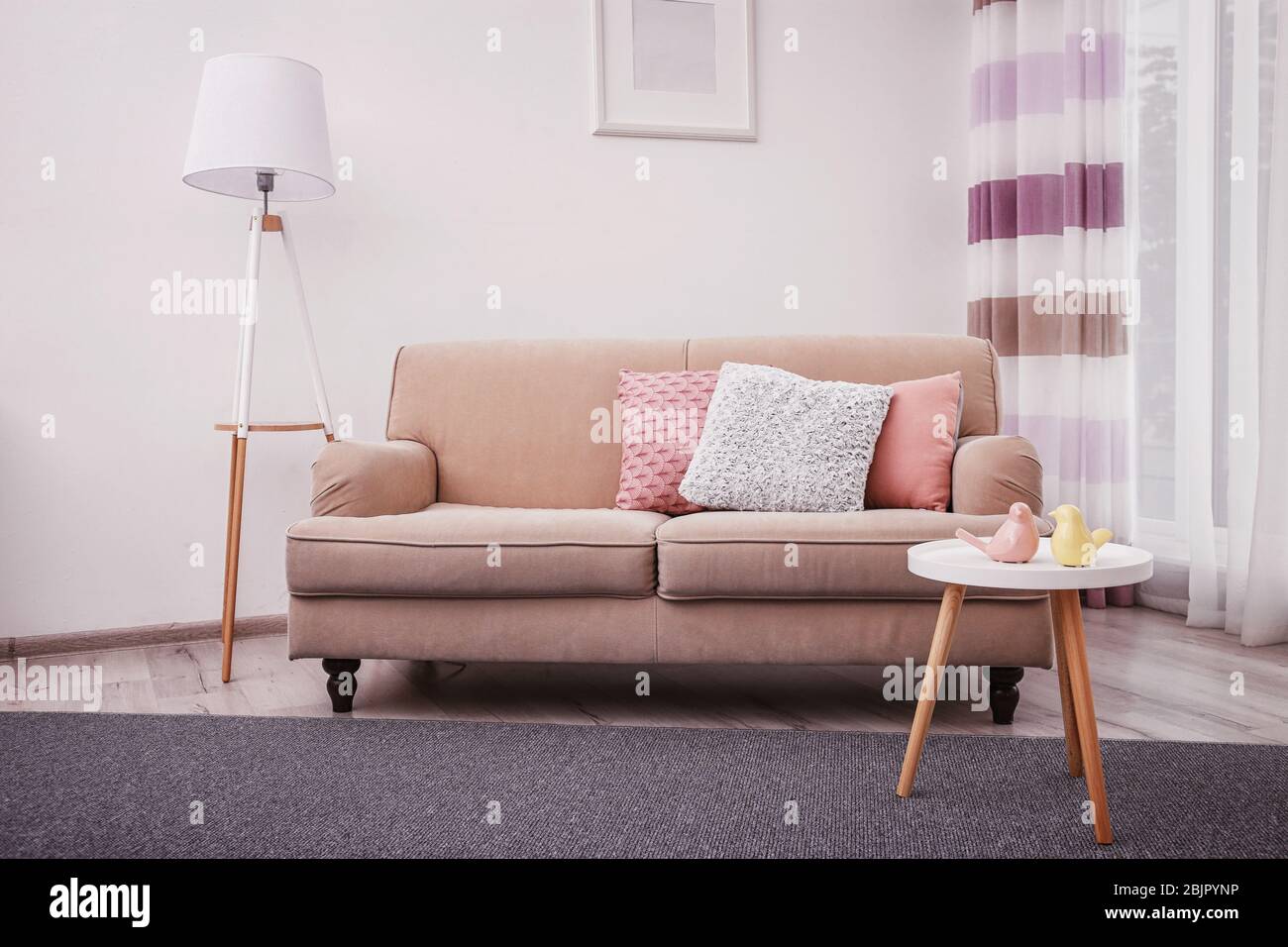 Modern living room interior with cozy sofa Stock Photo - Alamy