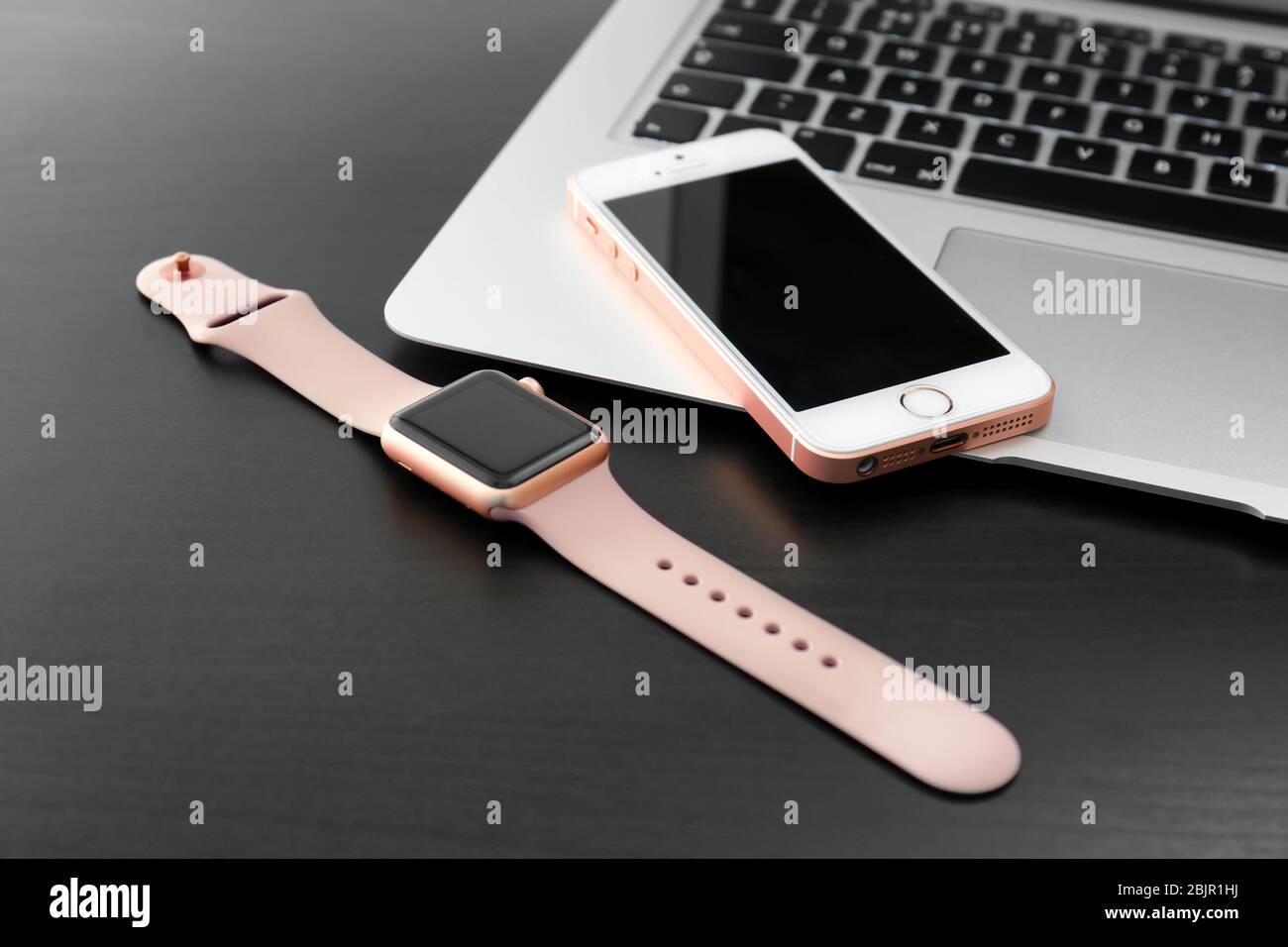 KIEV, UKRAINE - OCTOBER 17, 2017: Rose Gold iPhone SE, MacBook and Apple Watch on table Stock Photo