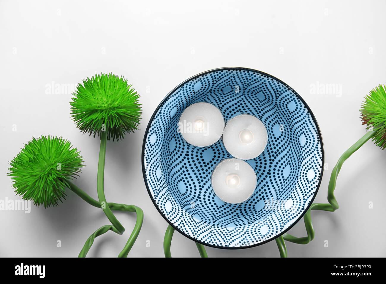 Composition with burning candles on white background Stock Photo - Alamy
