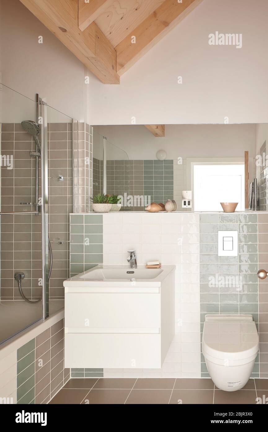 Tiled bathroom with wooden vaulted ceiling. Spencer Courtyard, London