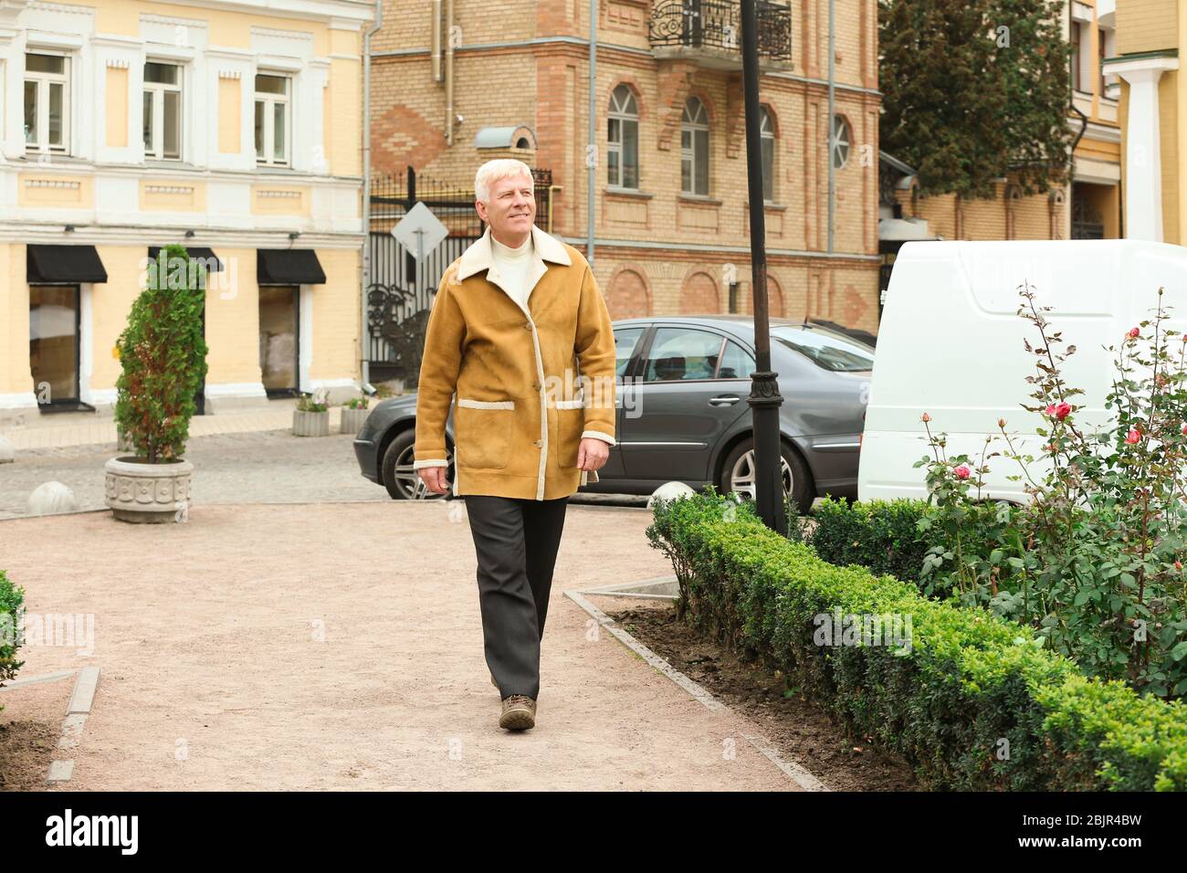 Mature man walking outdoors hi-res stock photography and images - Alamy