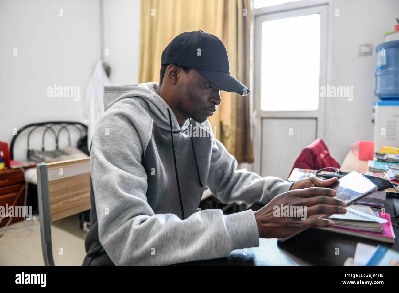 (200430) -- CHANGCHUN, April 30, 2020 (Xinhua) -- Mustapha studies at the dormitory in Changchun University of Chinese Medicine in Changchun, northeast China's Jilin Province, April 27, 2020. Mustapha Abdul Raheem has experienced two epidemics in the past six years: one was the Ebola in West Africa in 2014, during which he witnessed sufferings and aspired to study medicine; the other was the COVID-19. This time as a medical student in China, he was better prepared, both professionally and mentally. TO GO WITH 'Feature: An African medical student's fight against COVID-19 in China' (Xinhua/Yan L Stock Photo