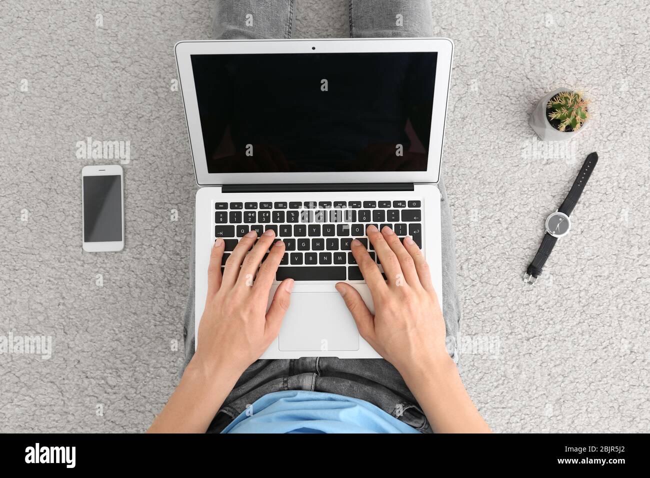 Man using laptop while sitting on floor, top view Stock Photo - Alamy