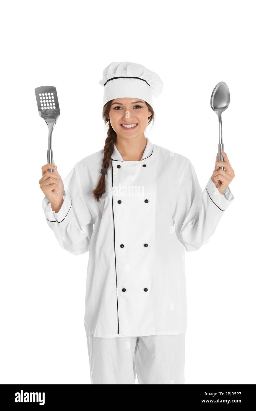 Young female chef with spoon and spatula, isolated on white Stock Photo