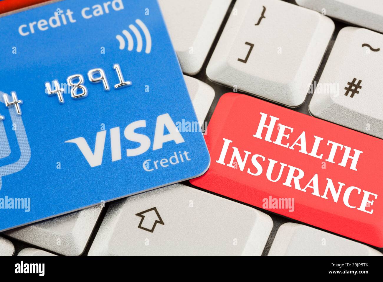 Visa credit card on a keyboard with a HEALTH INSURANCE on a red enter key.  Paying for private healthcare concept. England UK Britain Stock Photo -  Alamy