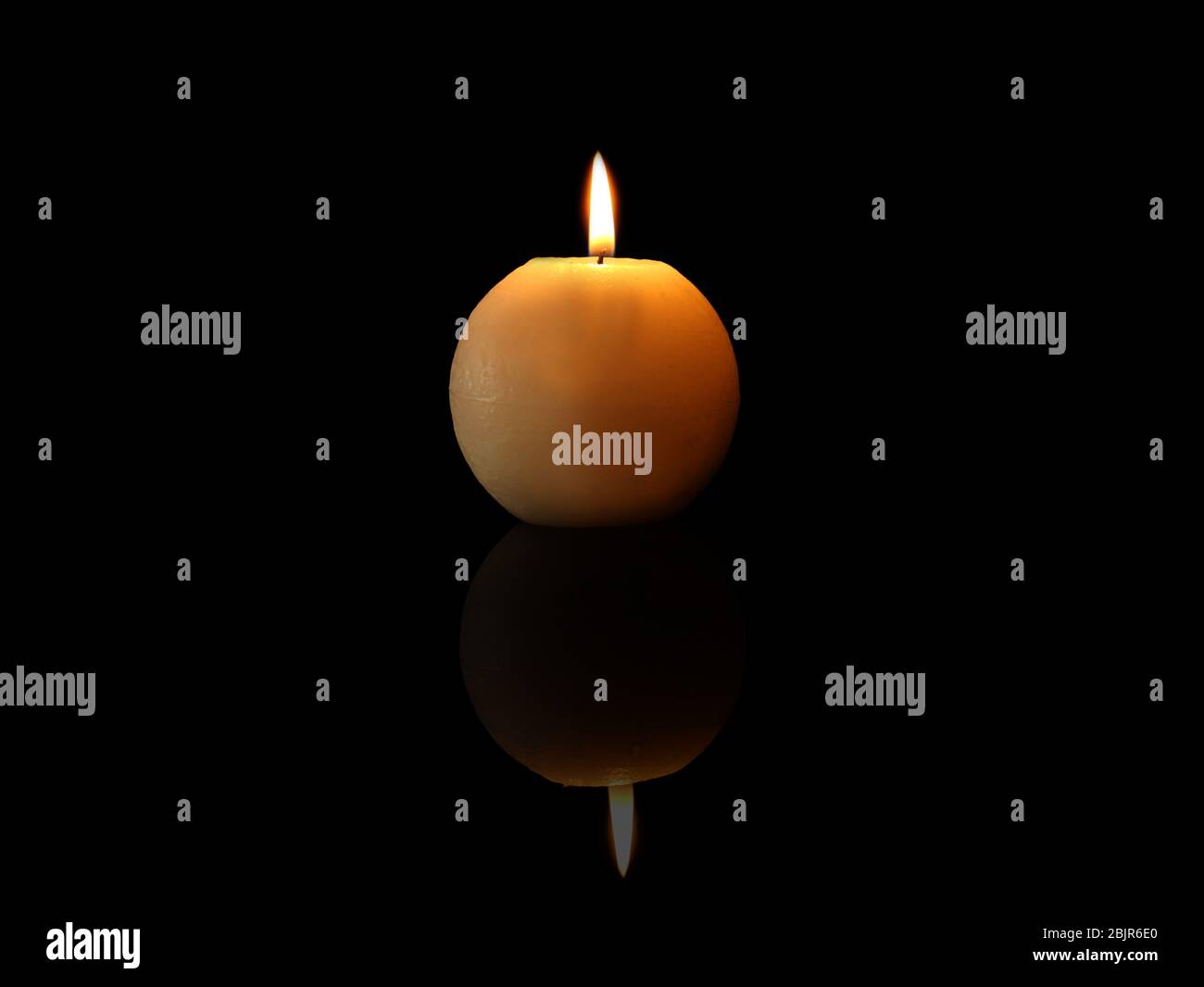 Burning candle on black background Stock Photo