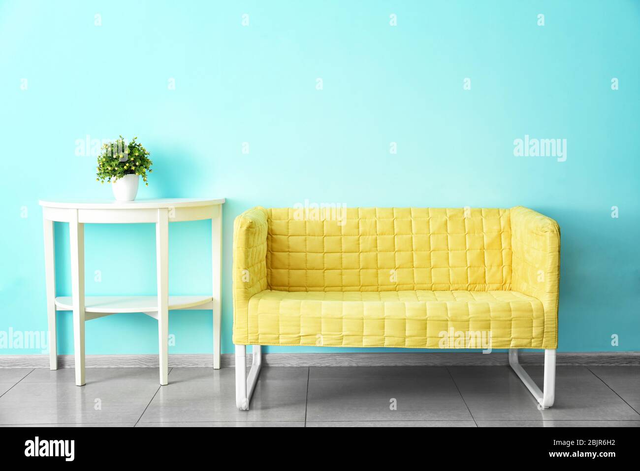 Cozy couch in room with minimalistic interior Stock Photo Alamy