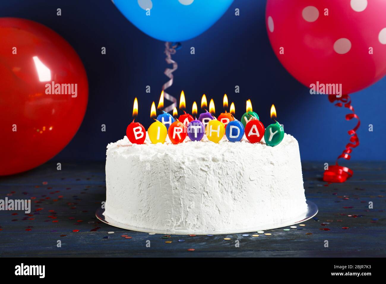 Cake with "Happy birthday" candles on table Stock Photo - Alamy