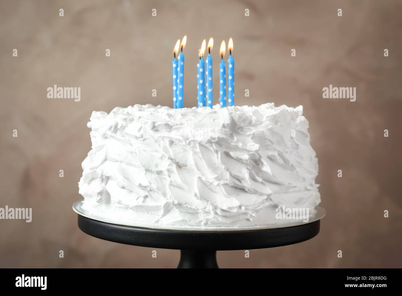 Delicious birthday cake with candles on stand Stock Photo - Alamy