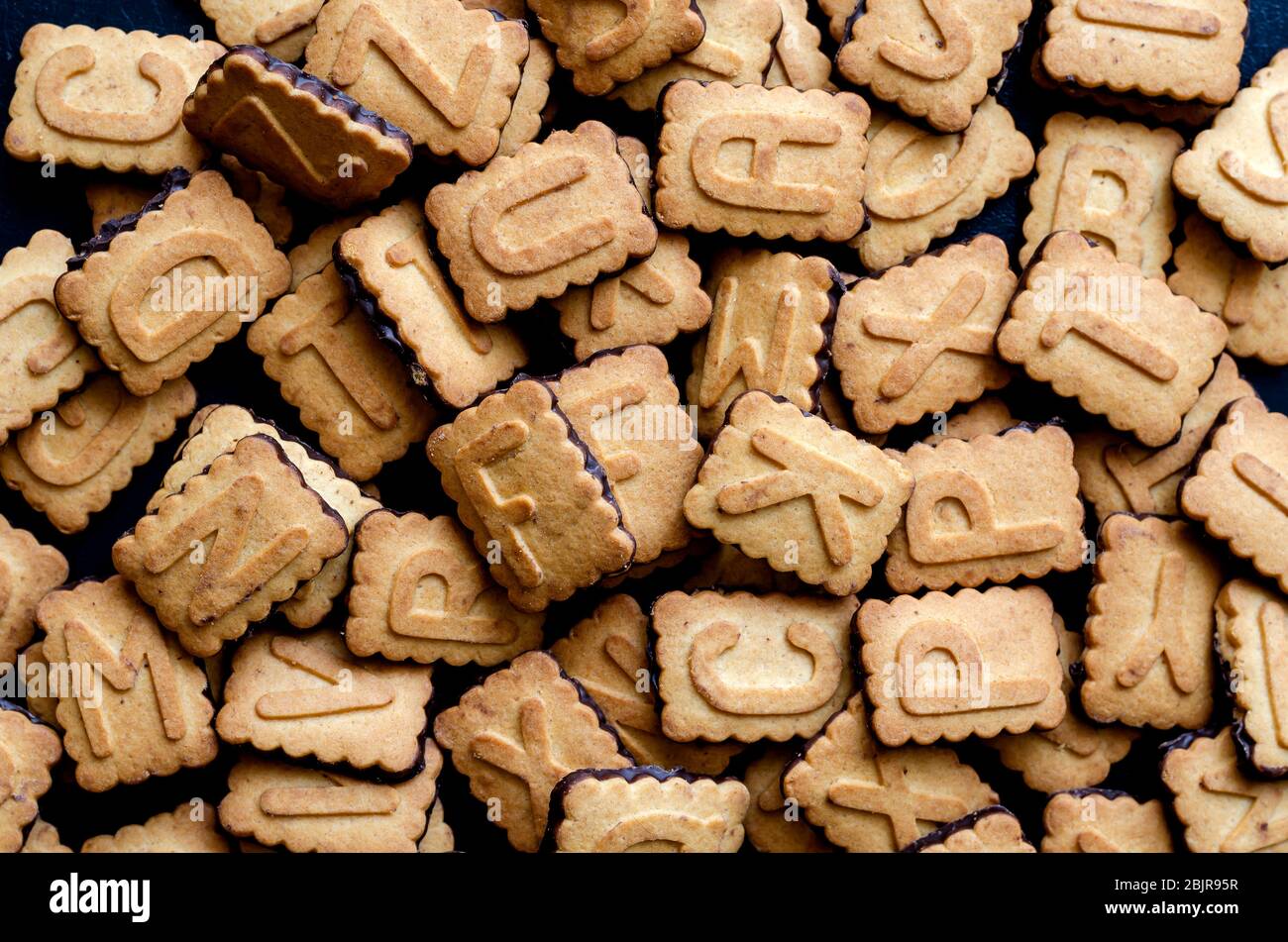 Cookies alphabet closeup. A pile of biscuits with English letters