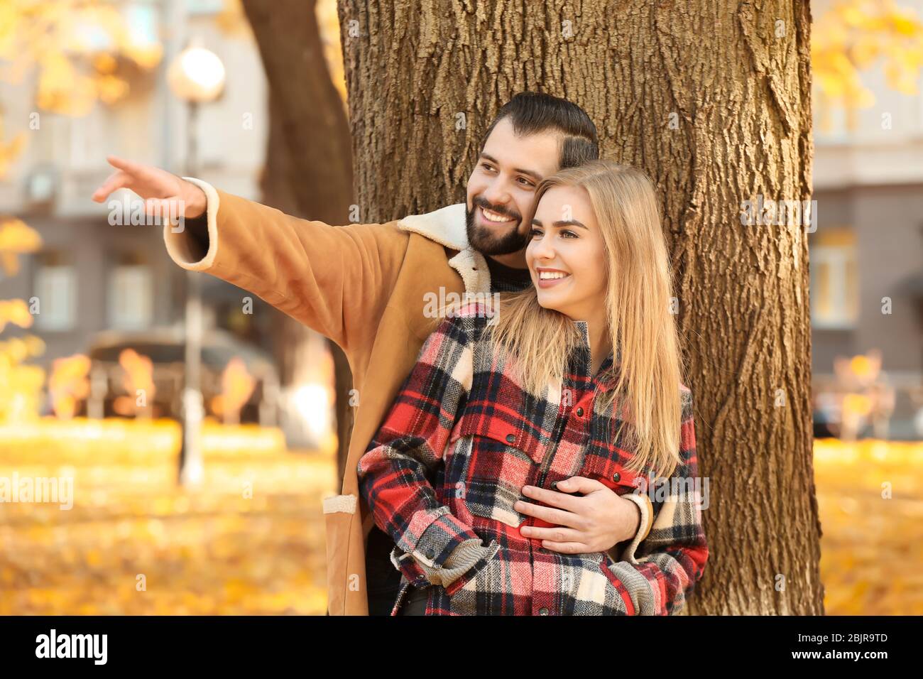 Young couple in park on autumn day Stock Photo - Alamy
