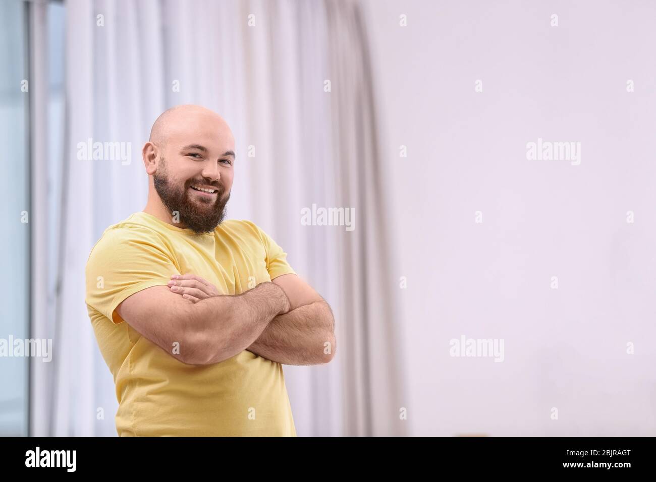 Overweight young man at home Stock Photo