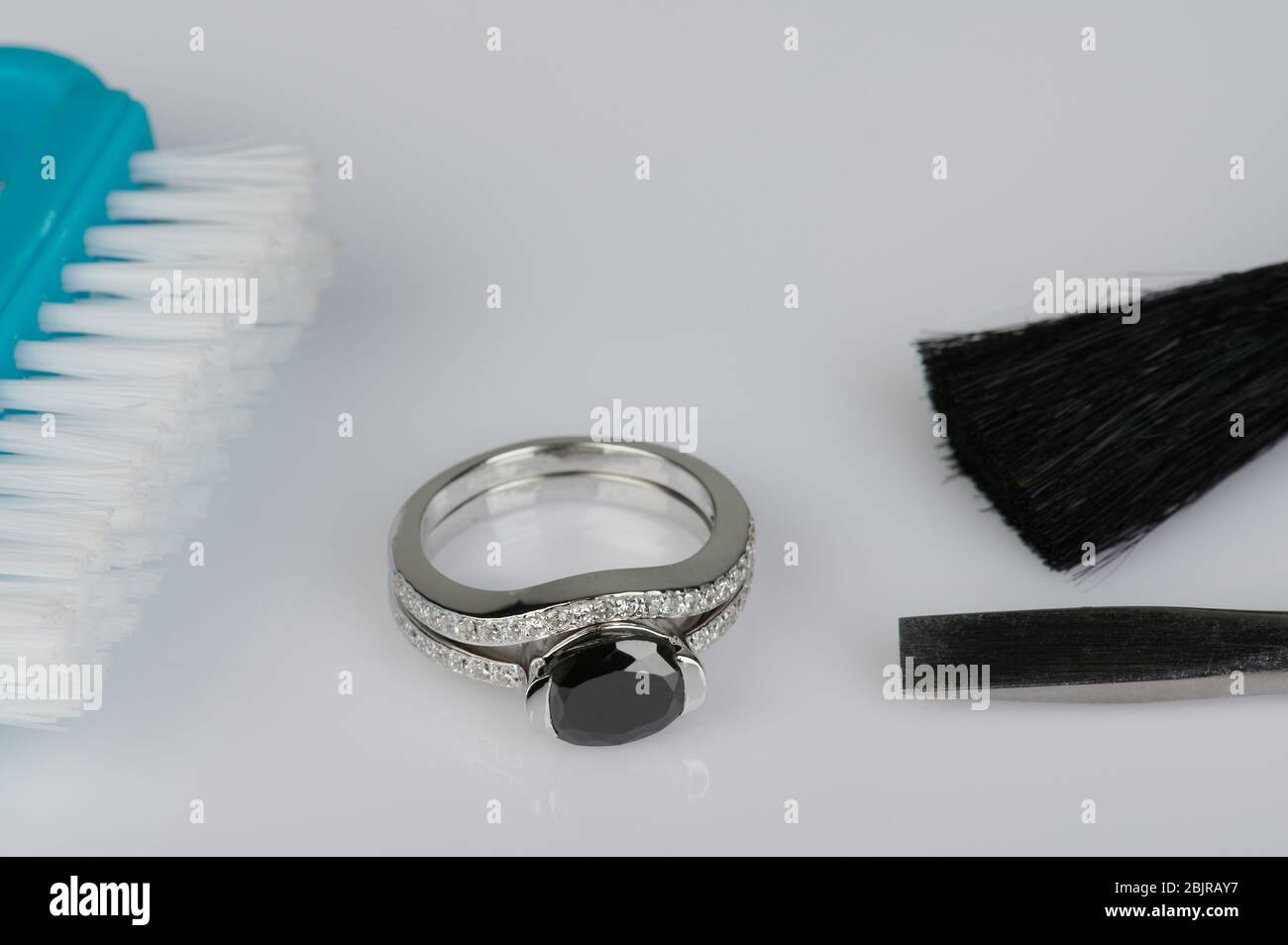 Polishing jewelry theme. Cleaning luxury ring with tool Stock Photo