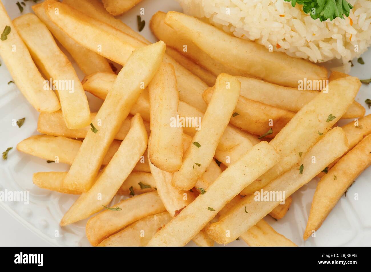 French fries with herbs macro close up view on plate Stock Photo