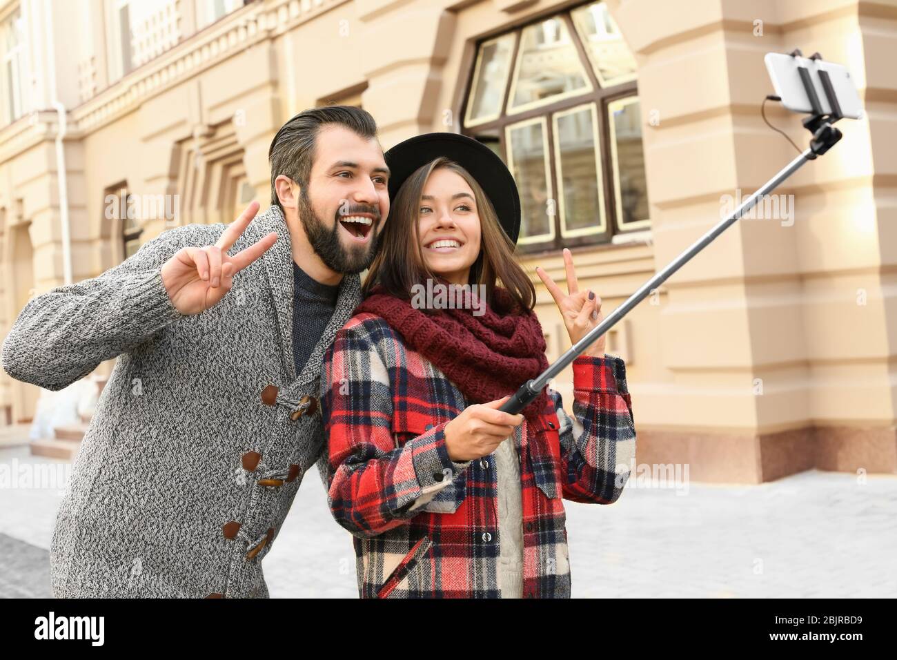 Young man walking selfie stick hi-res stock photography and images - Alamy