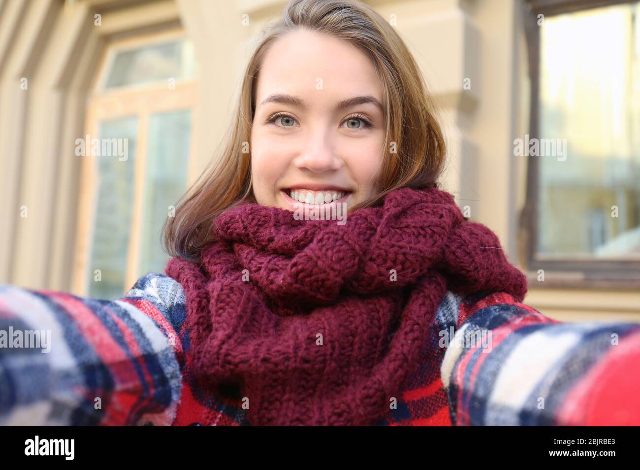 Young beautiful woman taking selfie outdoors Stock Photo - Alamy
