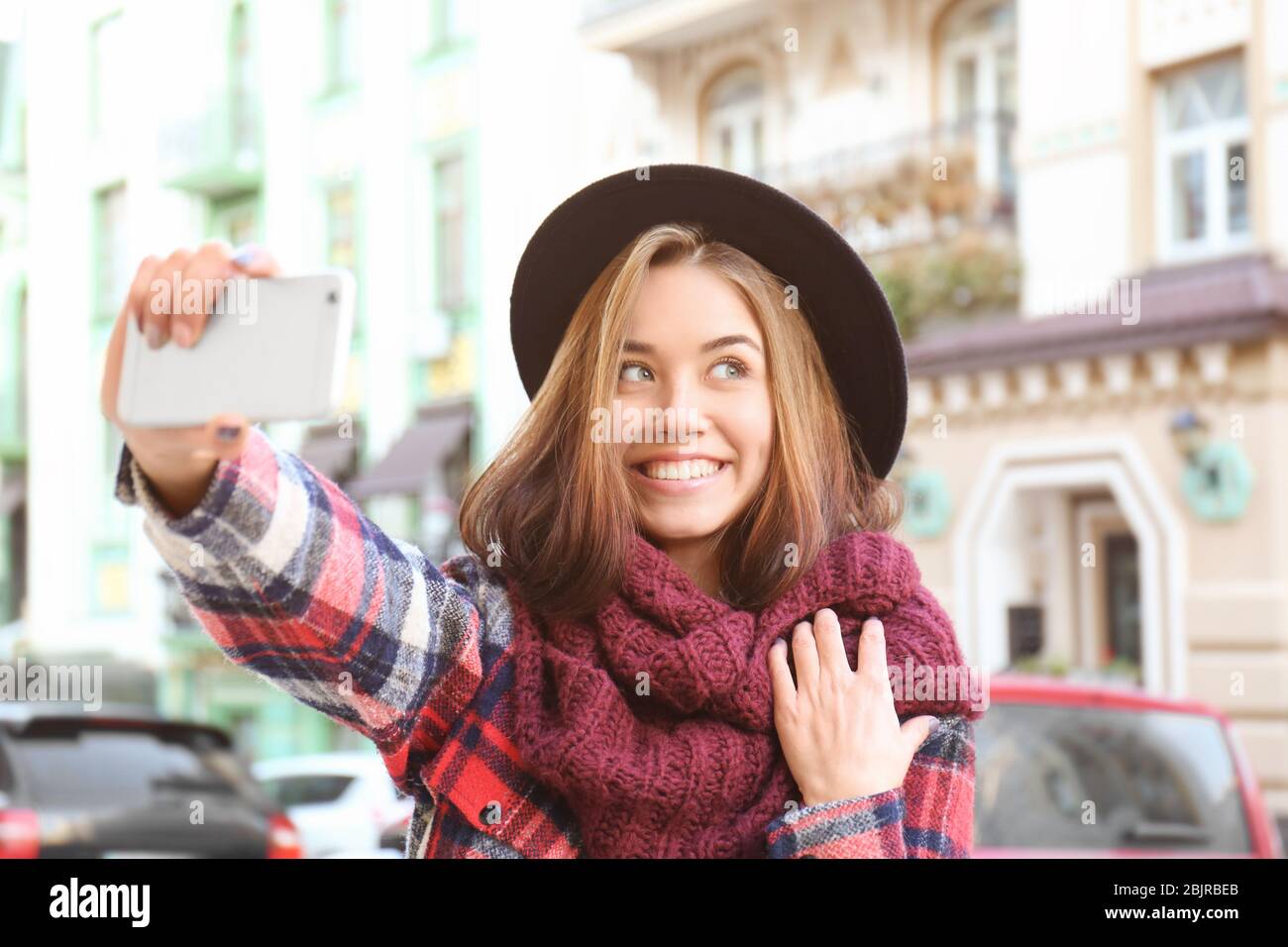 Young beautiful woman taking selfie outdoors Stock Photo - Alamy